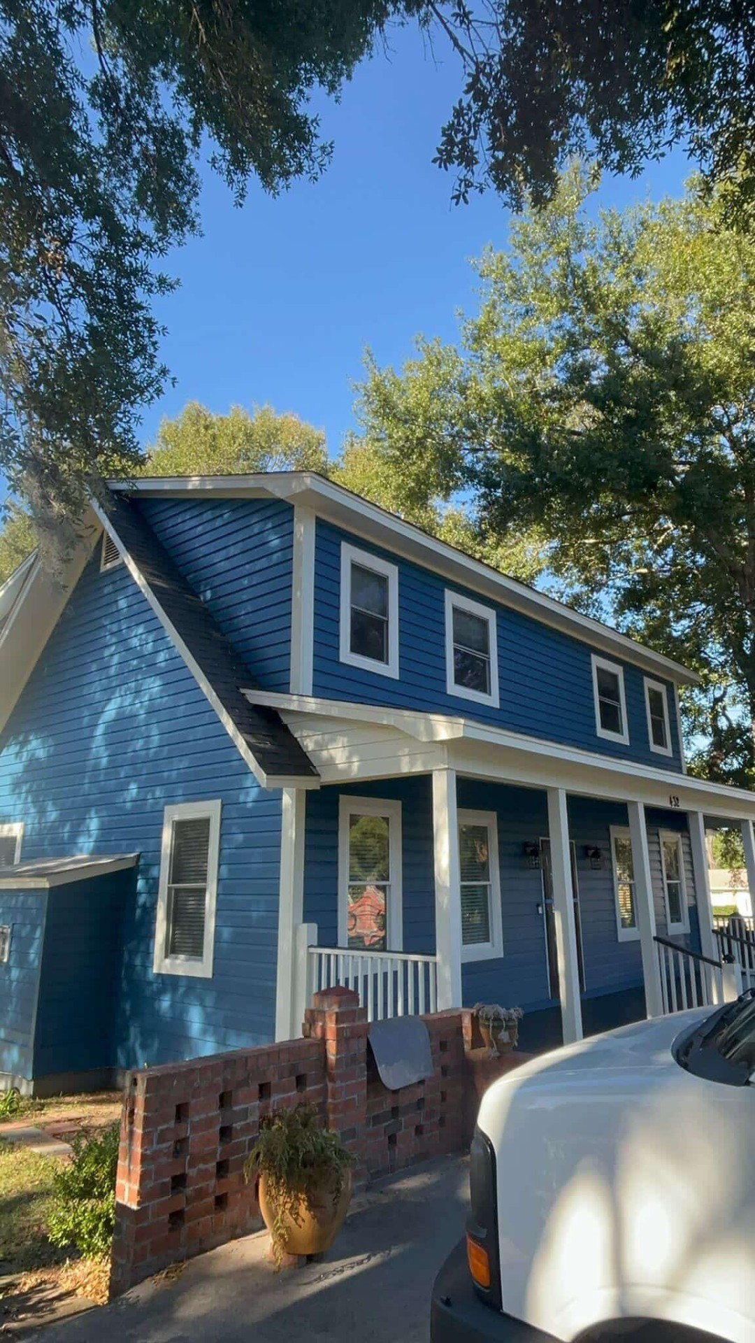Freshly painted Charleston coastal home with palm trees